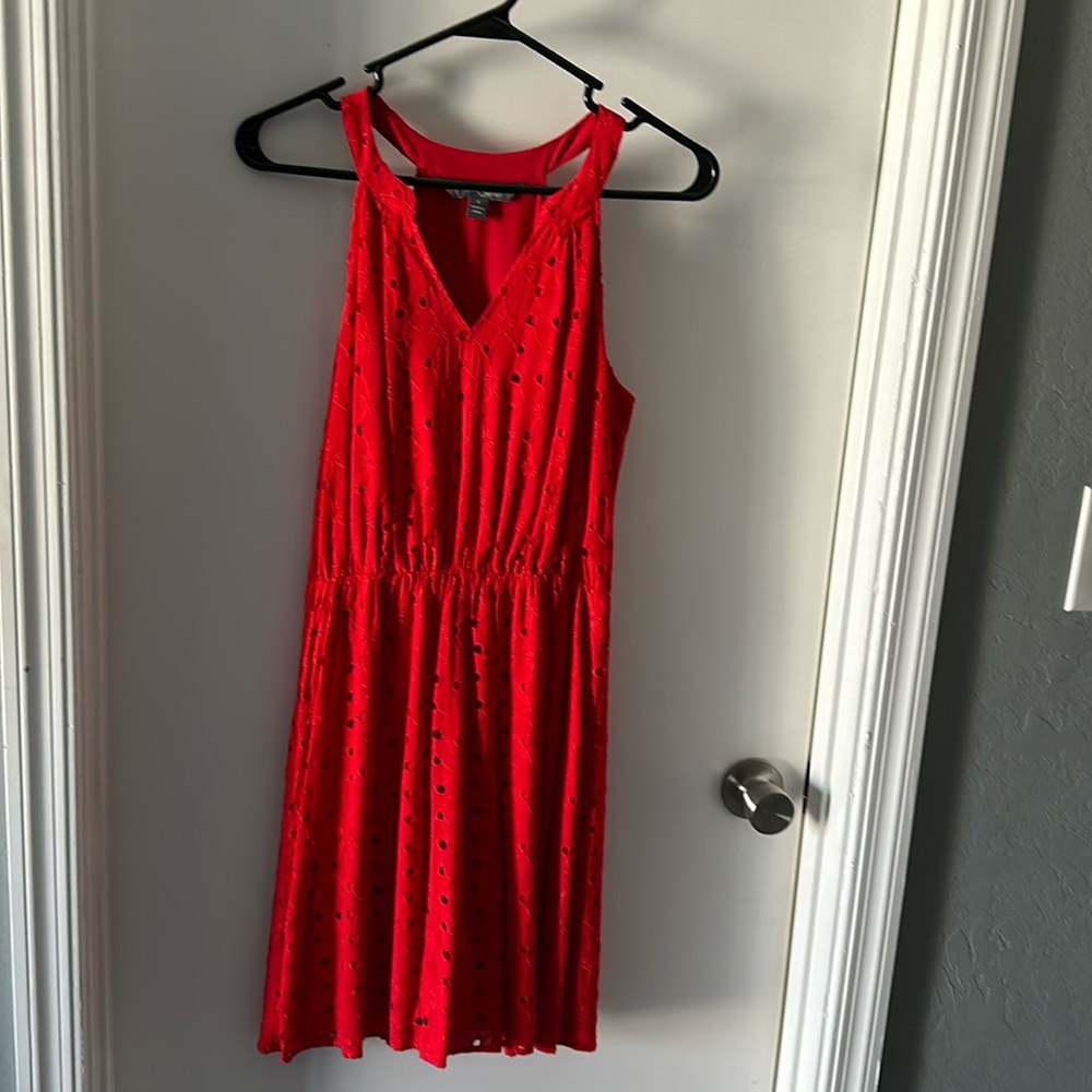 Sleeveless knee length red dress with embroidered pattern